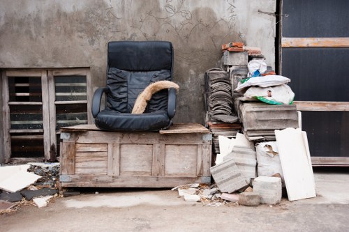 Construction site with builders waste being cleared in Forestgate